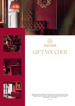 Sacher voucher with red and gold design, plush velvet seating, ornate lighting, and elegant café interior